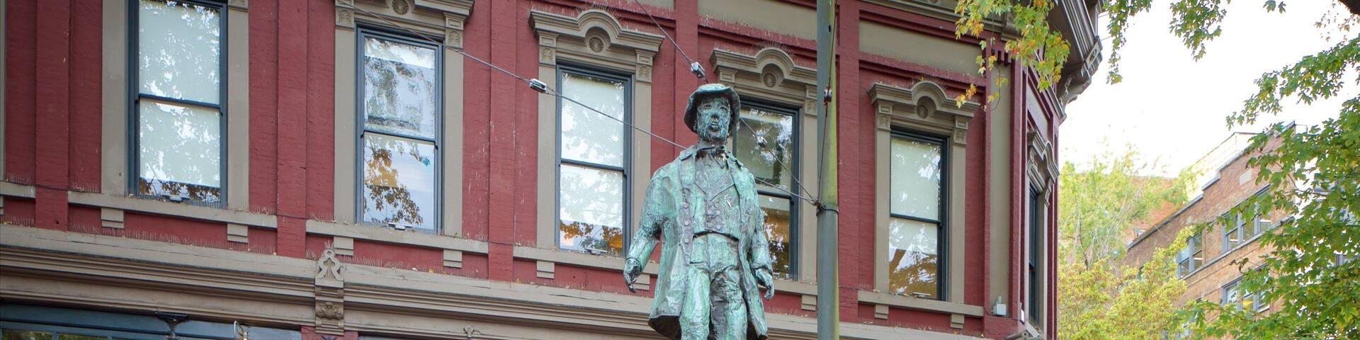 Gastown featuring heritage architecture, a statue or sculpture and street scenes