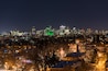contrast of the old houses of eastern montreal and its modern downtown seen at night