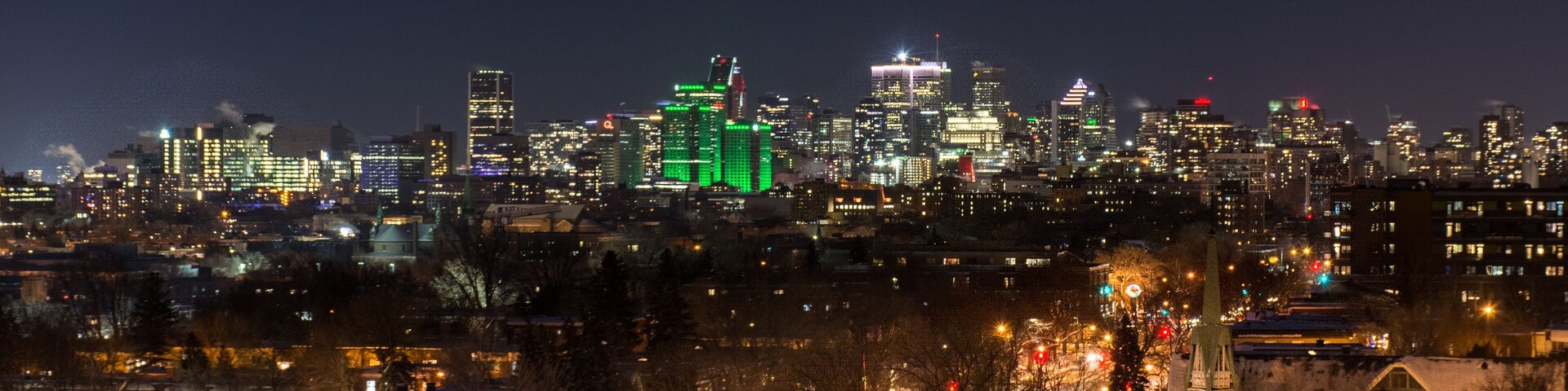 contrast of the old houses of eastern montreal and its modern downtown seen at night