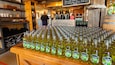 A wooden table filled with bottles of County Cider Lime.