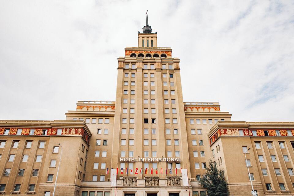 A large, beige building with the sign "HOTEL INTERNATIONAL" at the top.