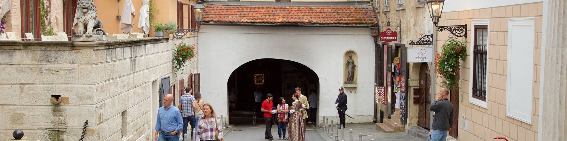 Stone Gate showing a small town or village and heritage architecture as well as a small group of people