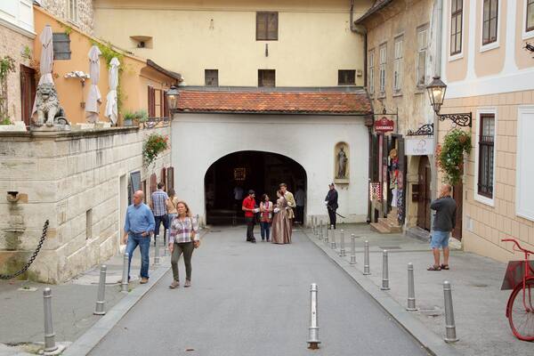 Stone Gate showing a small town or village and heritage architecture as well as a small group of people