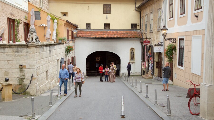 Stone Gate showing a small town or village and heritage architecture as well as a small group of people