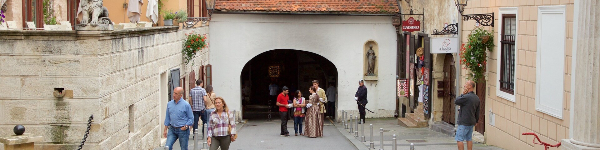 Stone Gate showing a small town or village and heritage architecture as well as a small group of people