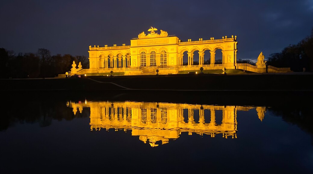 Vienna, Austria - January 20, 2020: The illuminated Glorietta at Schönbrunn Palace Park in winter at dusk against cloudy sky