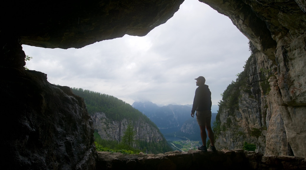 Obertraun showing mist or fog and caves as well as an individual male