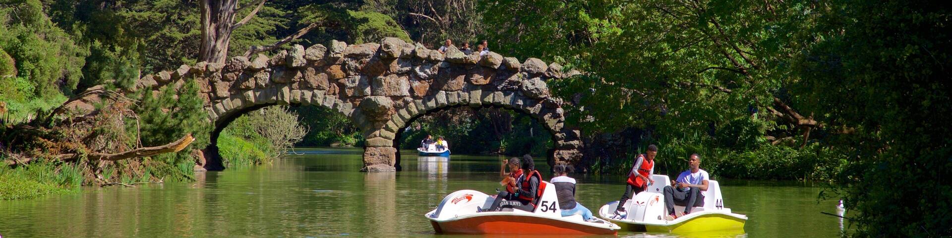 Stow Lake which includes boating, a river or creek and a bridge