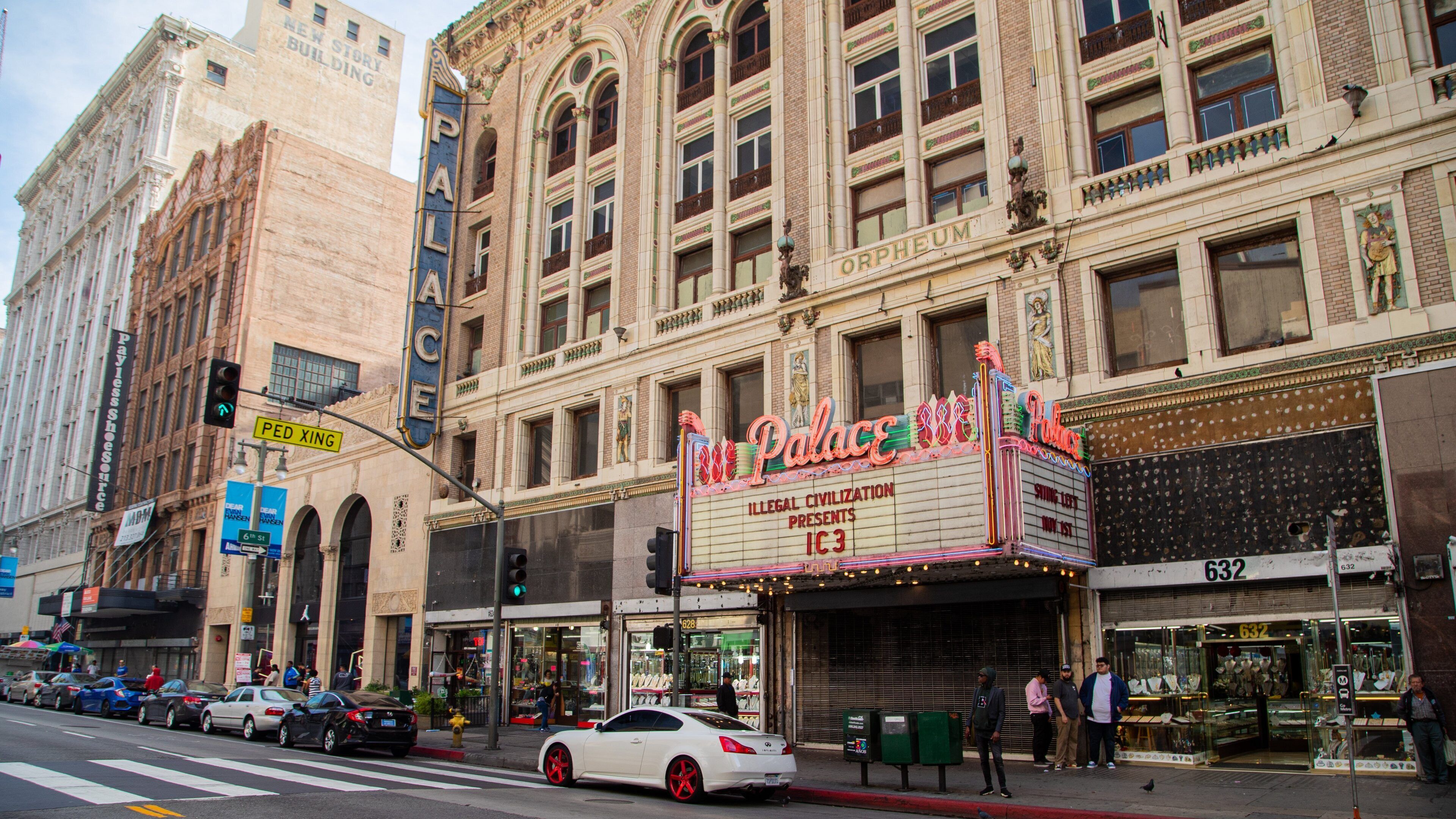 Palace Theater which includes a city, street scenes and signage