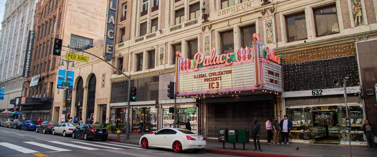 Palace Theater which includes a city, street scenes and signage