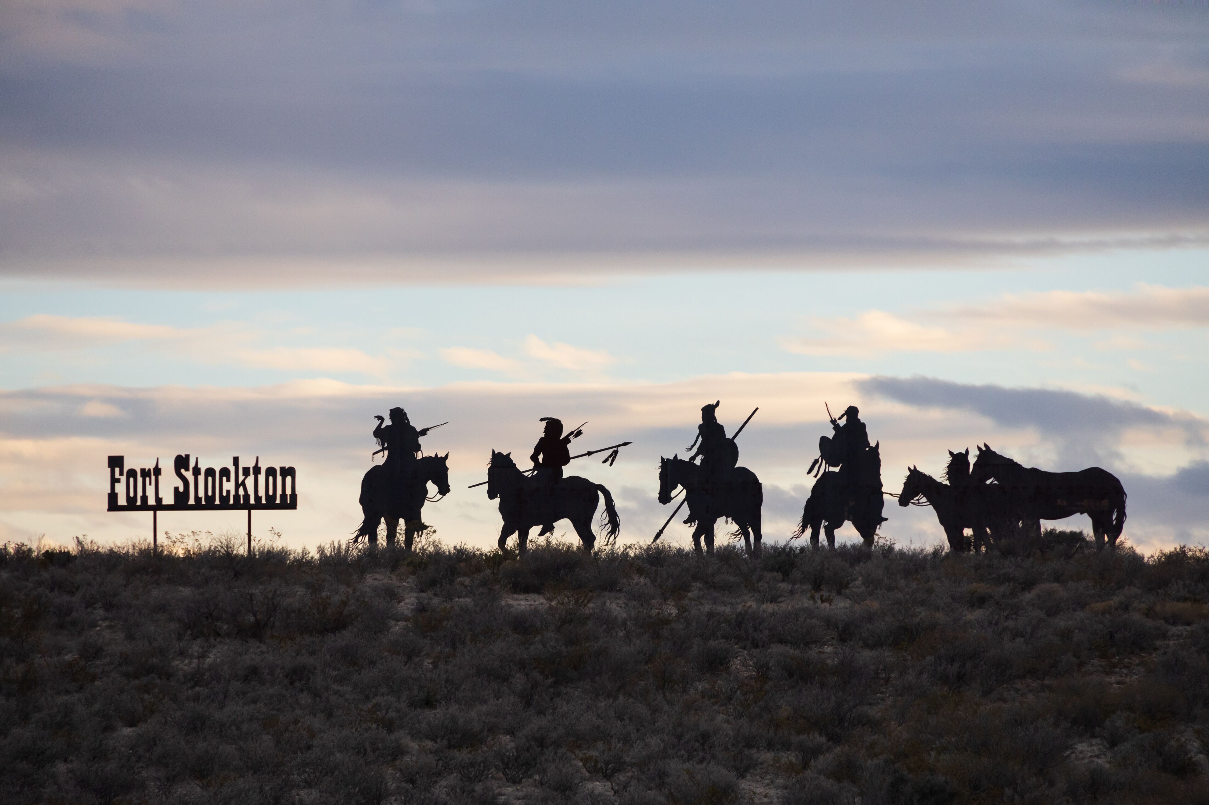 Fort Stockton Indians statues at sunset