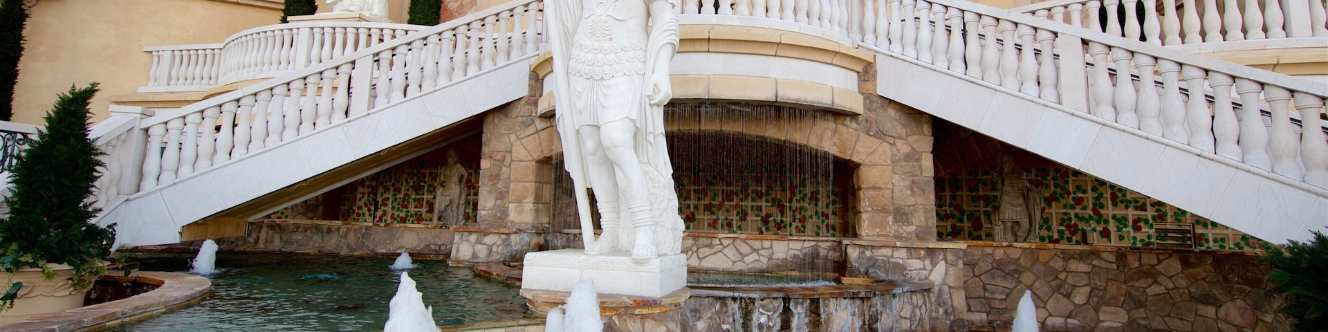 Reno showing a casino, a statue or sculpture and a fountain