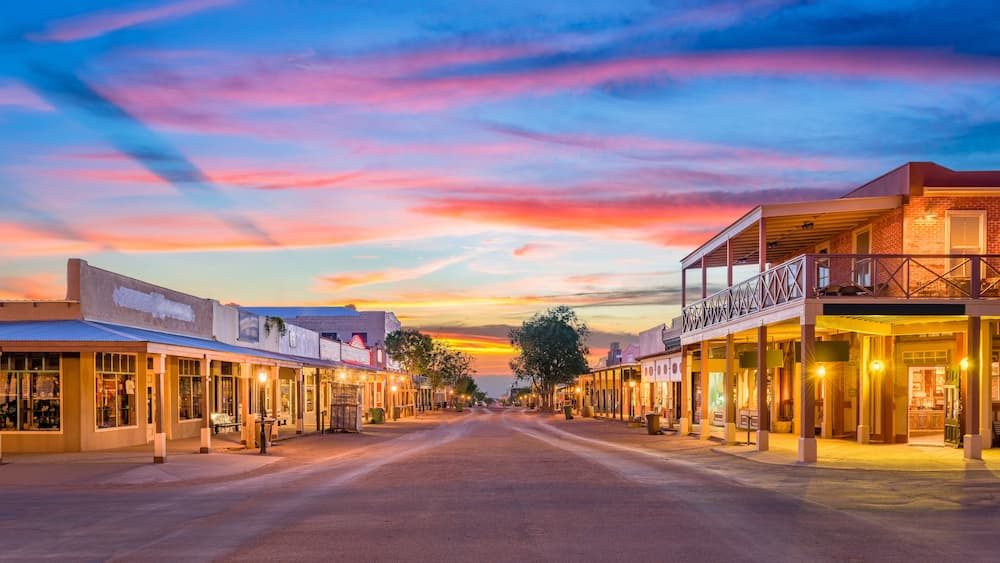 A sunset-lit street with buildings and a clear sky.