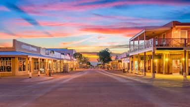 A sunset-lit street with buildings and a clear sky.