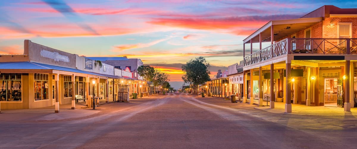 A sunset-lit street with buildings and a clear sky.