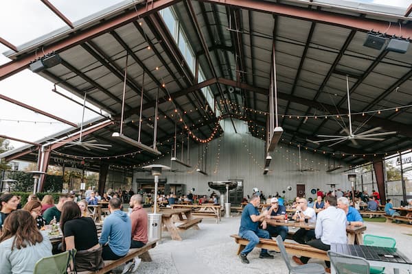 Saint Arnold Brewery showing outdoor eating as well as a large group of people