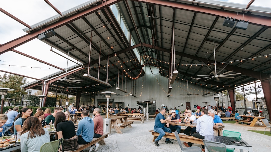 Saint Arnold Brewery showing outdoor eating as well as a large group of people