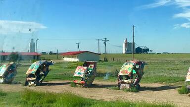 lug Bug Ranch -- also known as Bug Ranch, Bug Farm, and Buggy Farm -- was created in 2002. The five wrecked Volkswagen Beetles, buried hood-down in the ground, were the idea of the Crutchfield family, who owned the Longhorn Trading Post and Rattlesnake Ranch next door.
Slug Bug Ranch.
It began when a huge corporate Travel Plaza was built on the opposite side of the Crutchfields interstate exit. They figured they could stay in business if they could siphon away traffic with something eye-catching and engaging. Slug Bug Ranch seemed a natural choice: a parody of the popular Cadillac Ranch, 35 miles west. At the time, the Beetle wrecks were painted a pristine bright yellow, and a sign next to them encouraged, "Sign a Bug."
Slug Bug Ranch.
The Crutchfield's were right about one thing: Slug Bug Ranch has proved popular as an attraction. Unfortunately, it flopped as a business plan, and the Trading Post closed only a year after it was built. Its advanced state of decay is a testament to the vigorous love it has endured from Route 66 travelers, who have felt free to modify the abandoned artwork with spray paint and whatever crowbars, hammers, blowtorches, etc. they apparently carry in their vehicles.