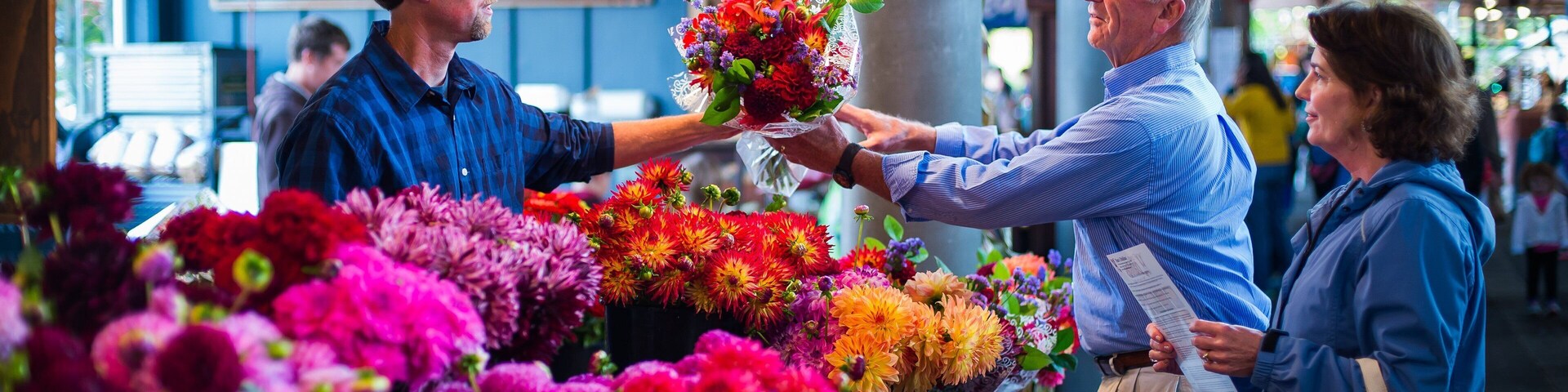 Olympia Farmers Market showing markets and flowers as well as a couple
