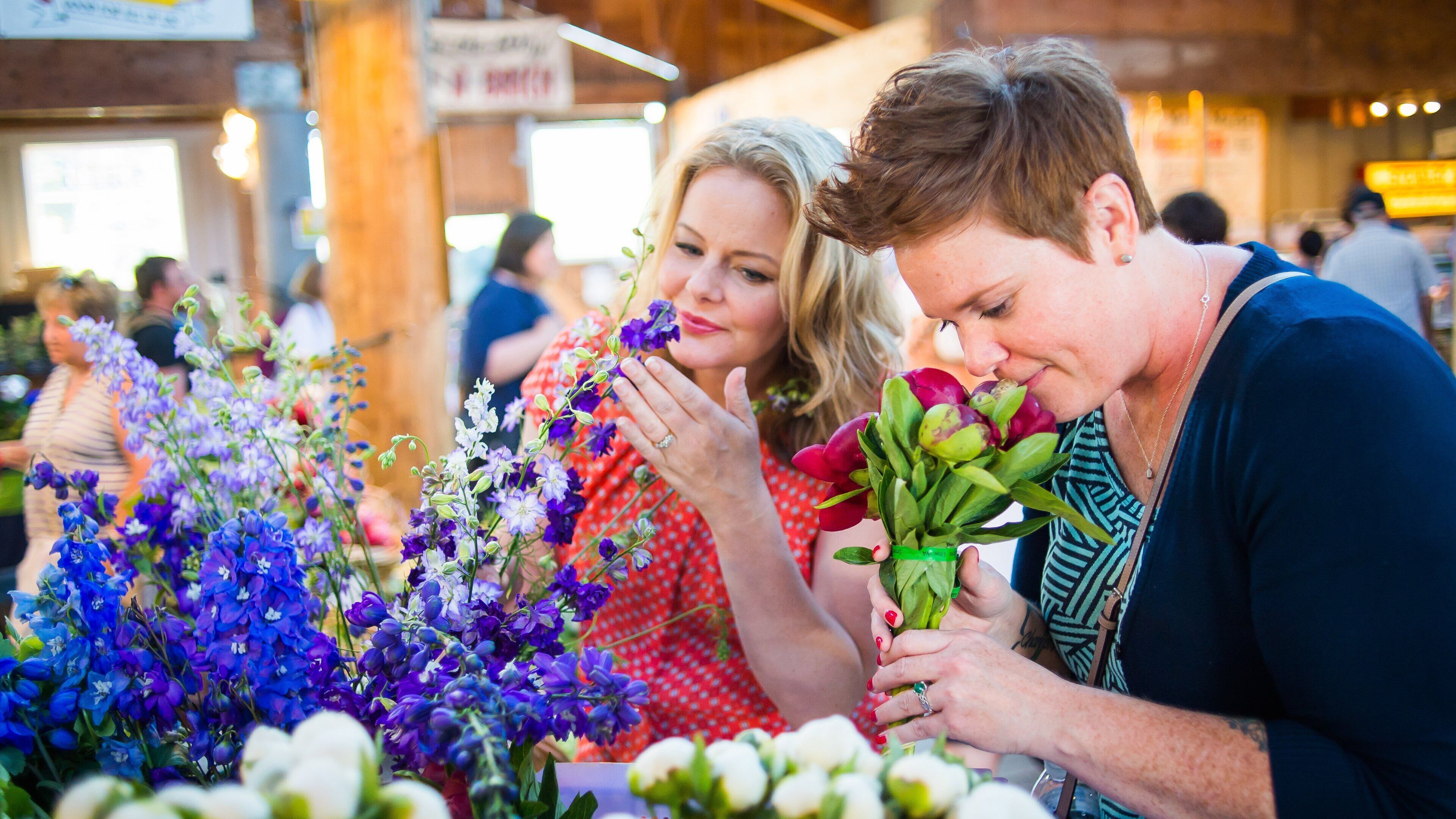Olympia Farmers Market which includes flowers as well as an individual femail