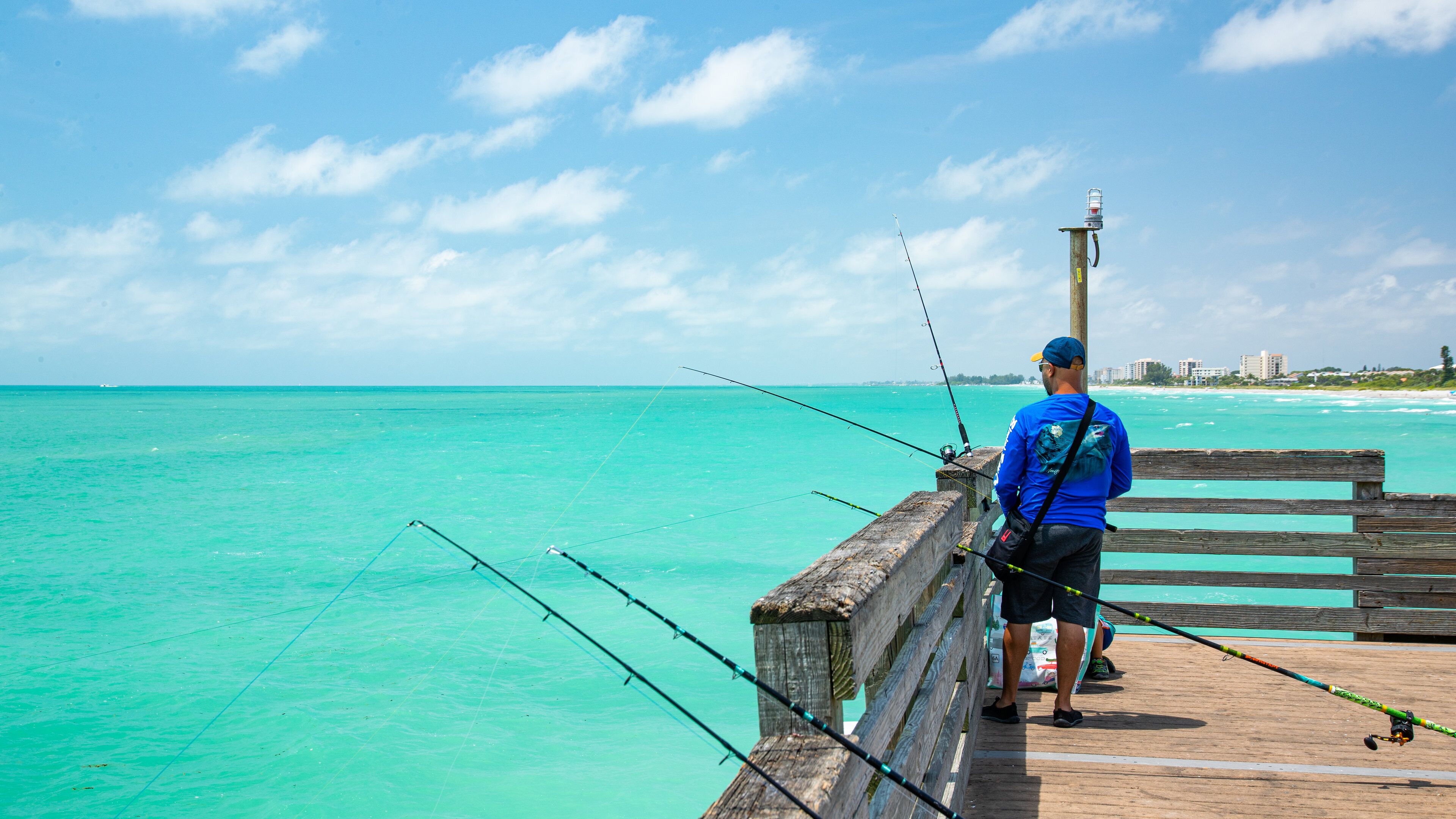 Venice Fishing Pier which includes general coastal views and fishing as well as an individual male