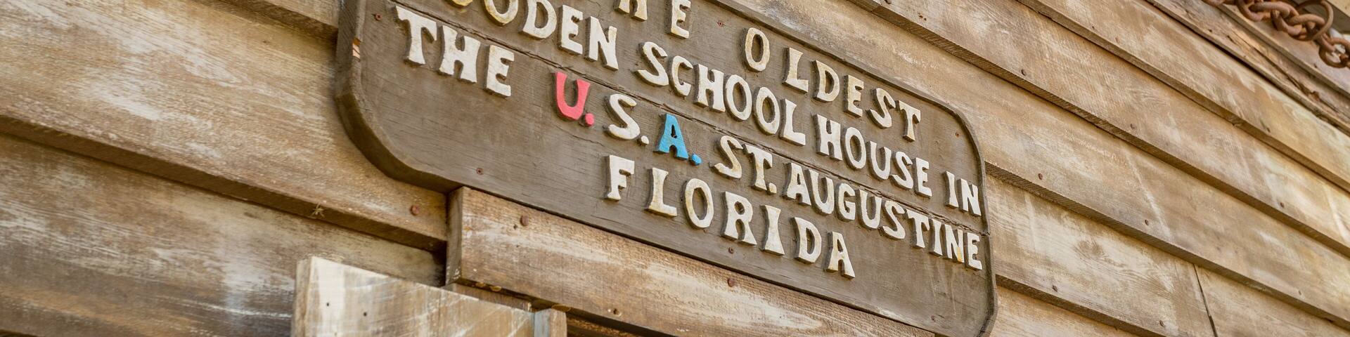 Oldest Wooden School House which includes signage