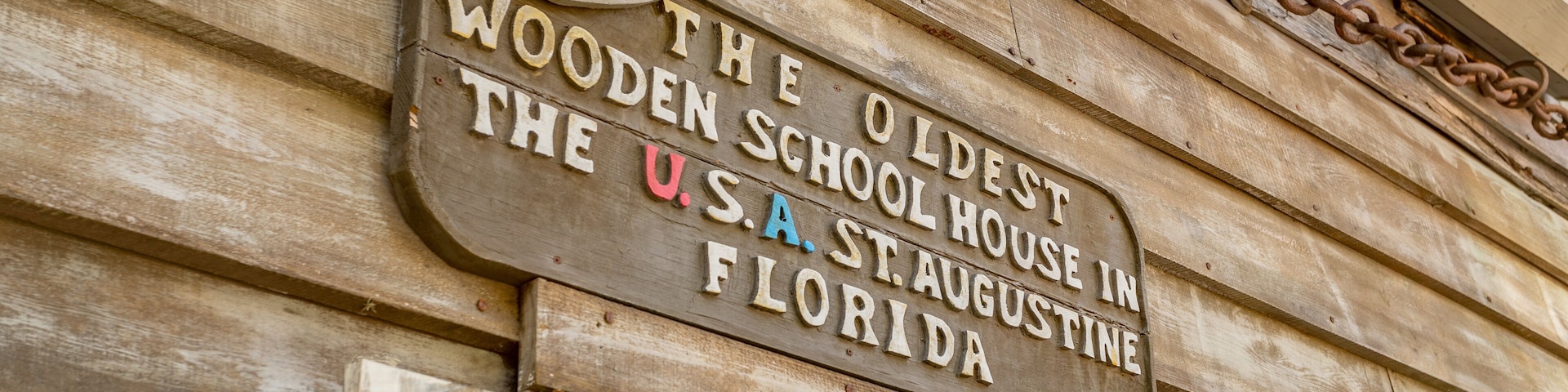 Oldest Wooden School House which includes signage