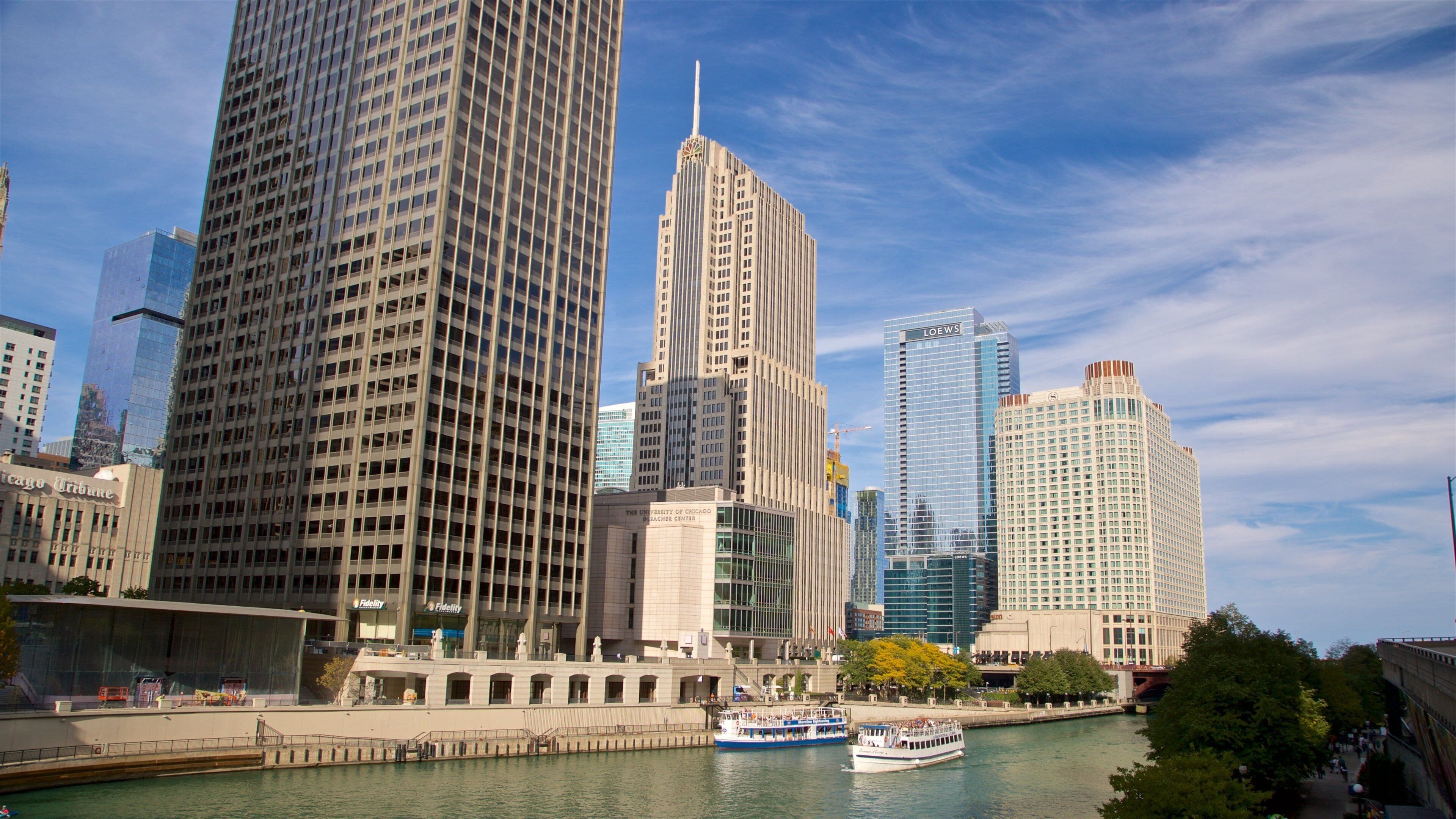 Chicago Riverwalk which includes a high rise building, a river or creek and a city