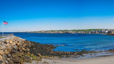 View of the sea from the beach. Seascape with American Flag waving at Back Habor of Sandy Bay in Rockport, Cape Anne, Massachusetts
