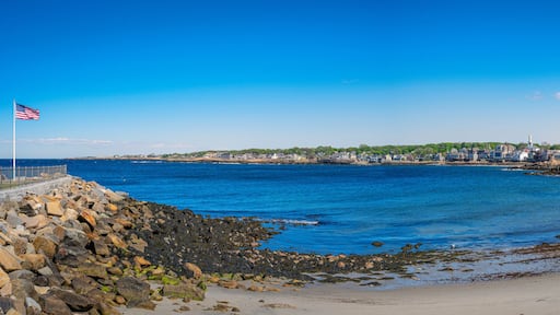 View of the sea from the beach. Seascape with American Flag waving at Back Habor of Sandy Bay in Rockport, Cape Anne, Massachusetts