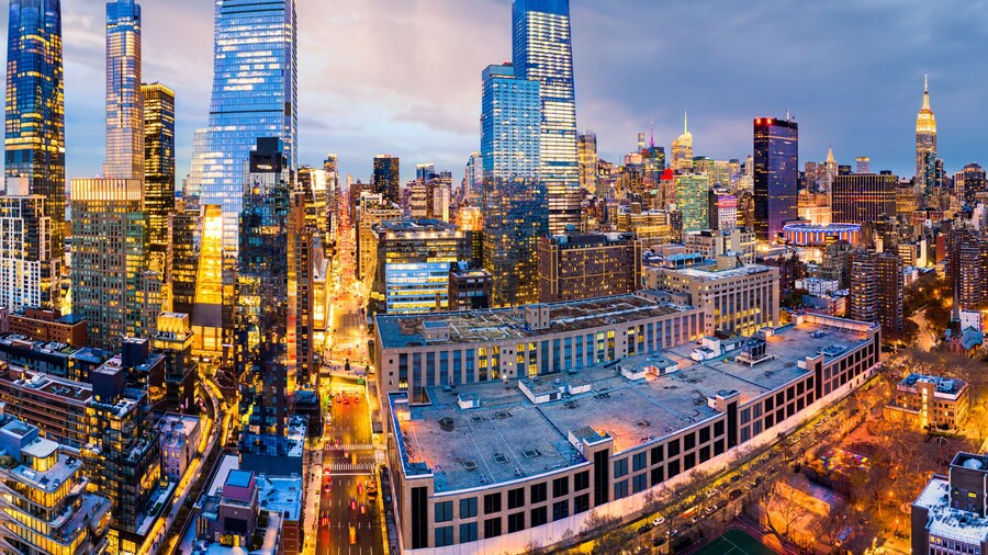 Aerial panorama of New York City skyscrapers at dusk as seen from above the 10th avenue and 29th street, close to Hudson Yards and Chelsea neighborhood