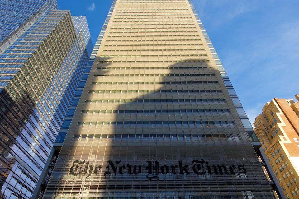 The New York Times building with a clear blue sky in the background.