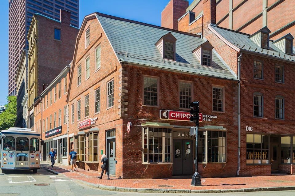 A brick building with a Chipotle Mexican Grill and a CityView bus stop.