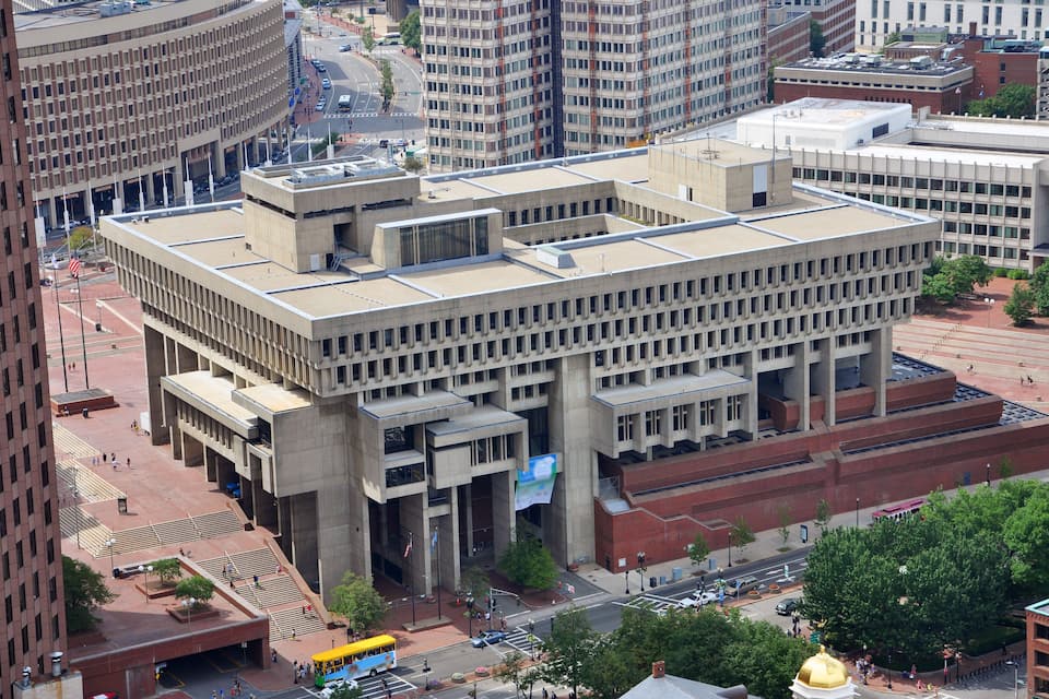 A large, multi-story building with a flat roof and a large banner.