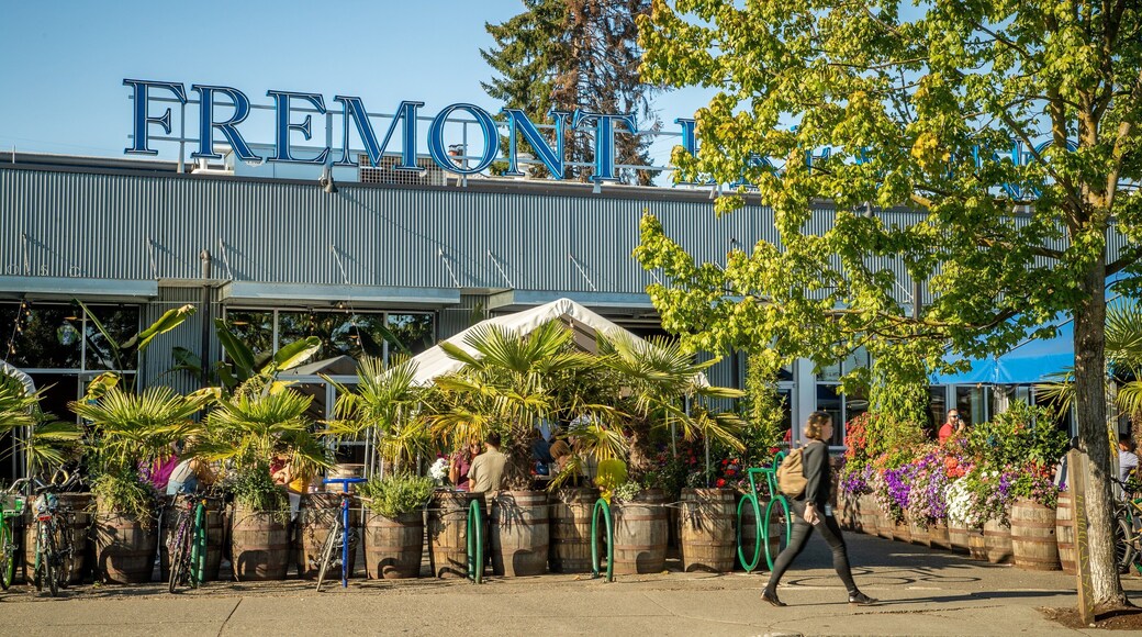 Fremont Brewing featuring signage and street scenes as well as an individual femail
