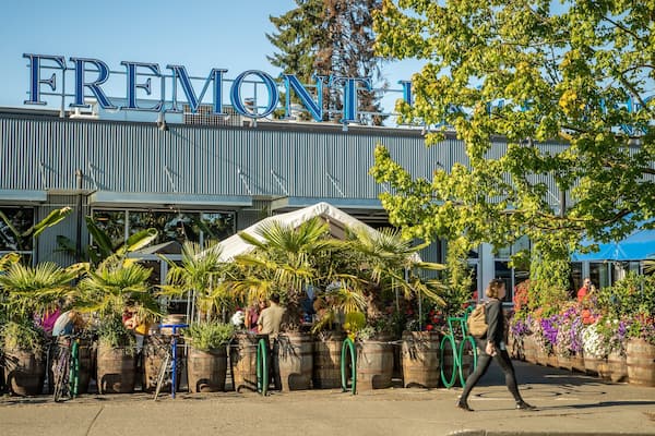 Fremont Brewing featuring signage and street scenes as well as an individual femail