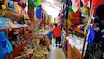A vibrant market with colorful textiles and woven baskets.