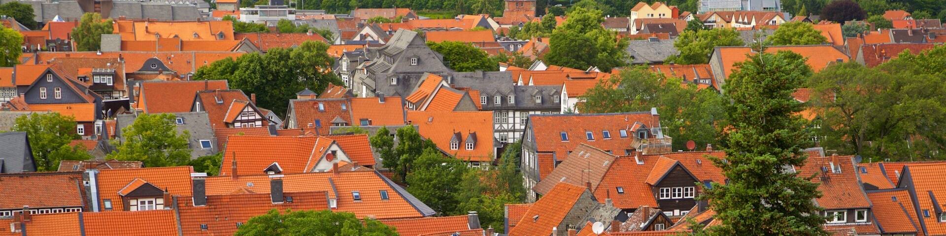 A densely packed urban area with red-tiled rooftops and a mix of traditional and modern architecture.