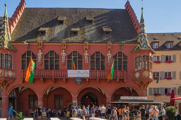 Historical Merchants\' Hall featuring heritage elements and outdoor eating as well as a large group of people