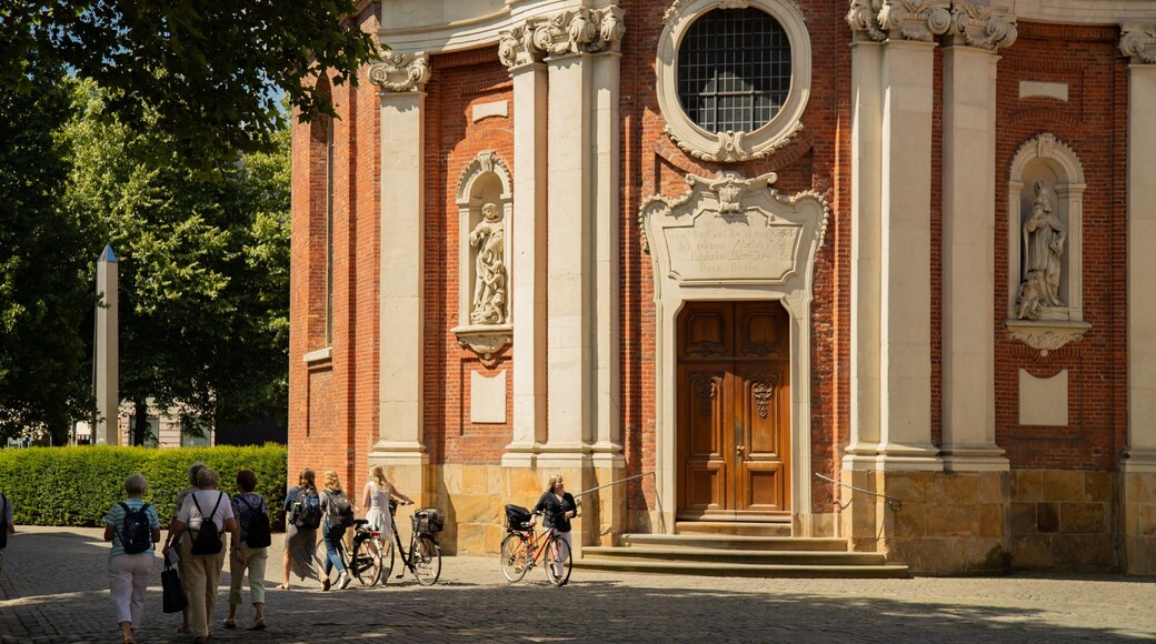 Clemenskirche featuring street scenes and heritage elements as well as a small group of people