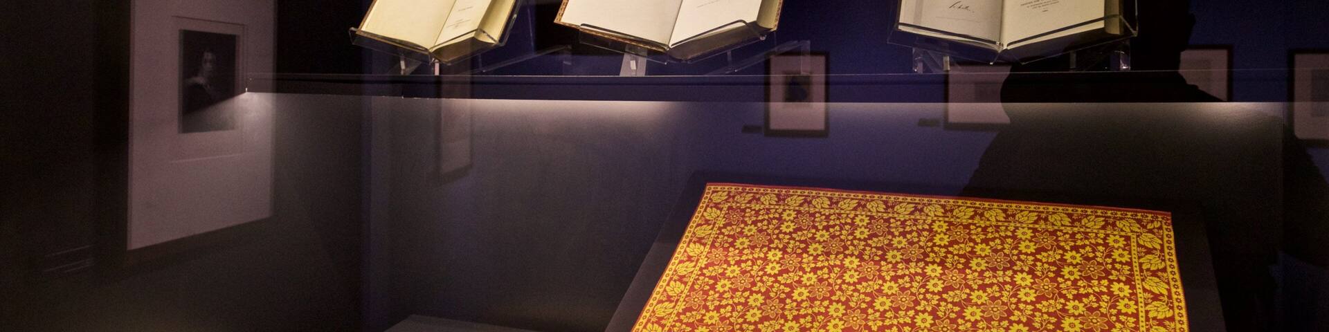 An exhibition with books and documents on display.