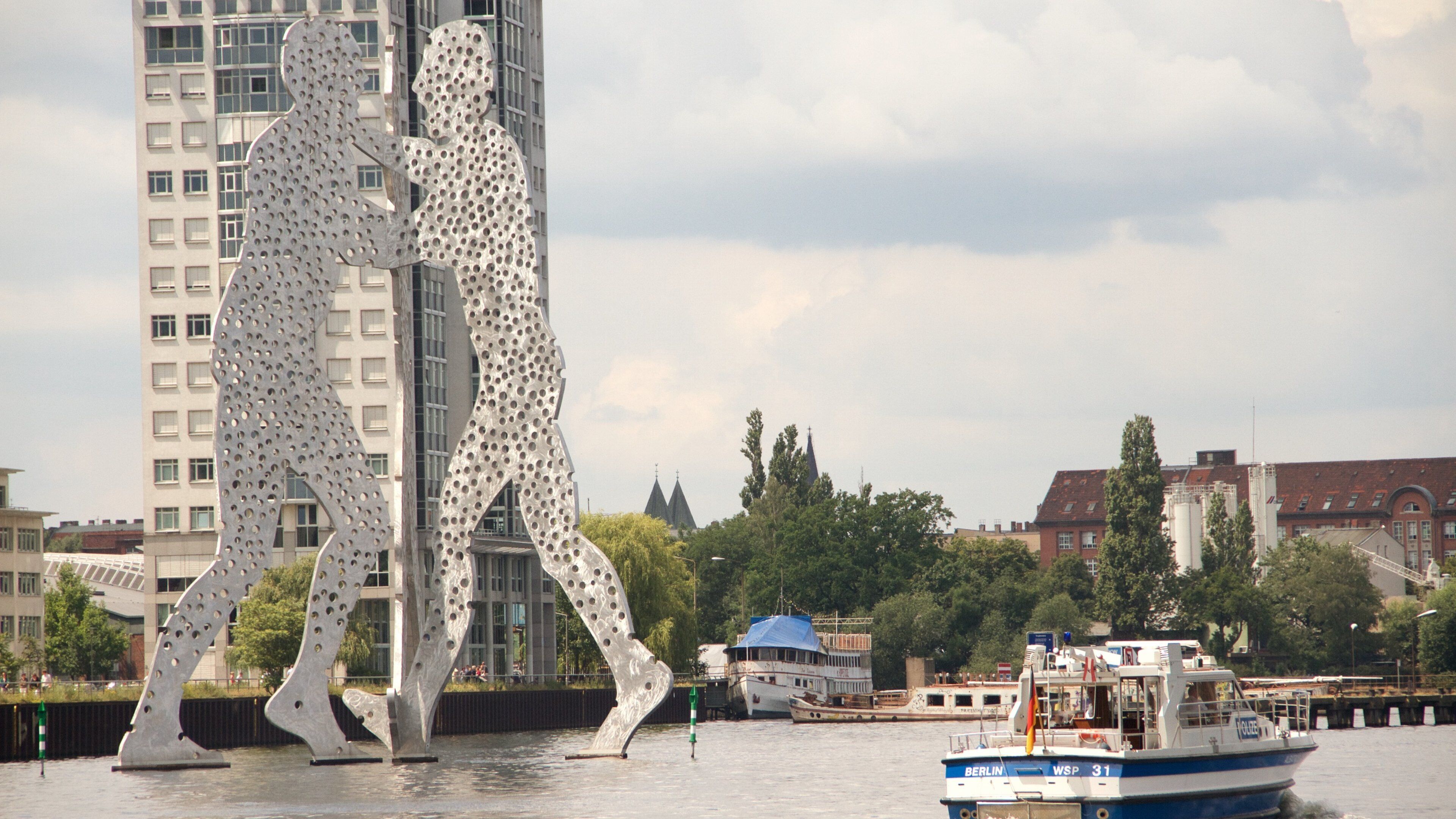 Molecule Man featuring boating, outdoor art and a city