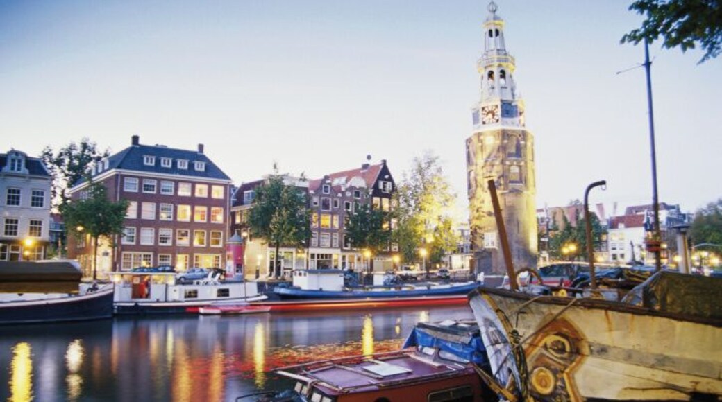 Netherlands, Holland, Amsterdam, Montelbaanstoren by canal, evening