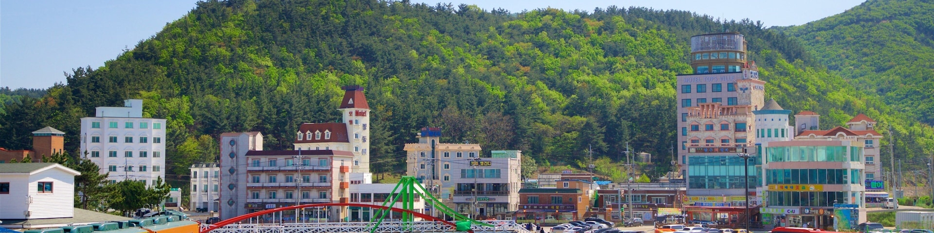Jeongdongjin Beach showing a bridge, a river or creek and a small town or village