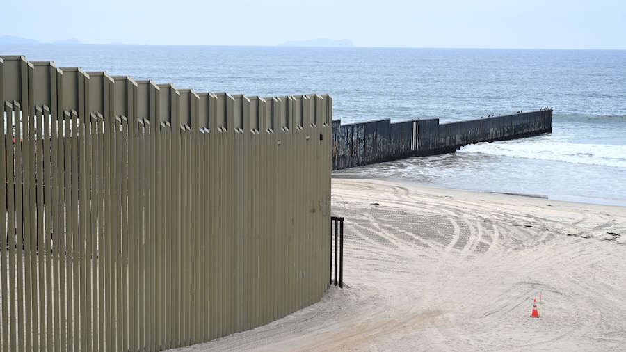 A fence on the United States - Mexico border where it meets the Pacific Ocean in Border Field State Park Beach