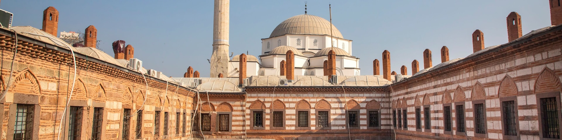Awesome view of Kizlaragasi Han Caravanserai and Hisar Mosque in Izmir, Turkey. Izmir is a popular tourist destination in Turkey.