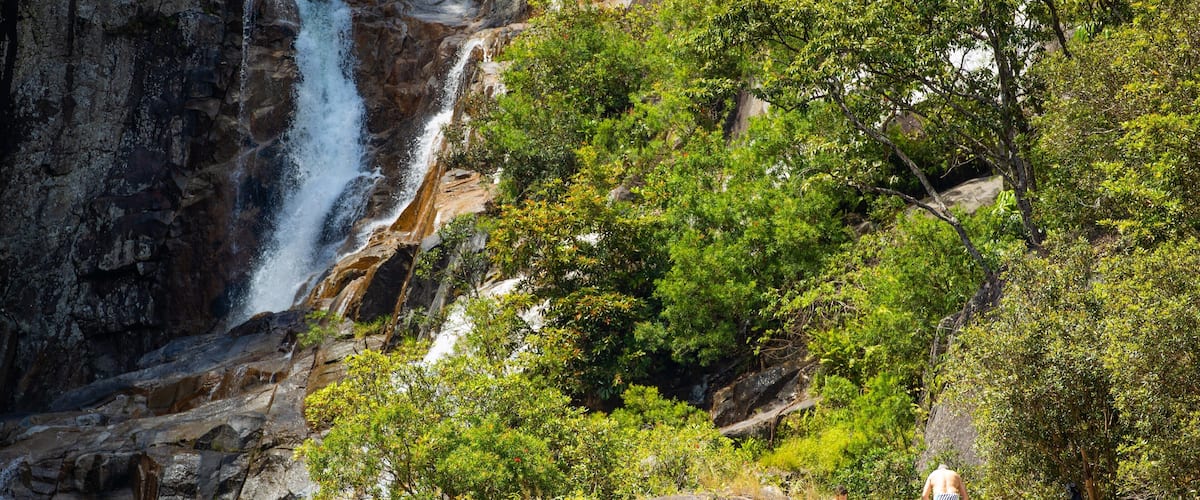 Behana Gorge featuring a waterfall as well as an individual male
