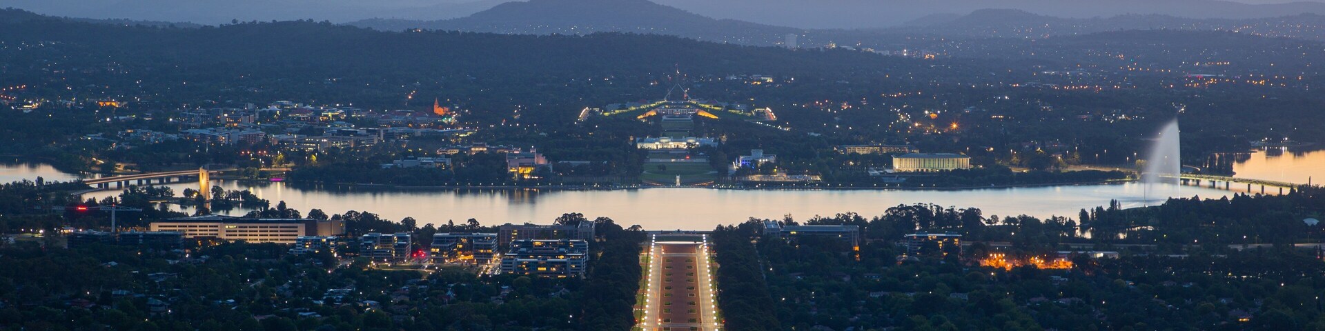Mount Ainslie showing landscape views, a sunset and a city
