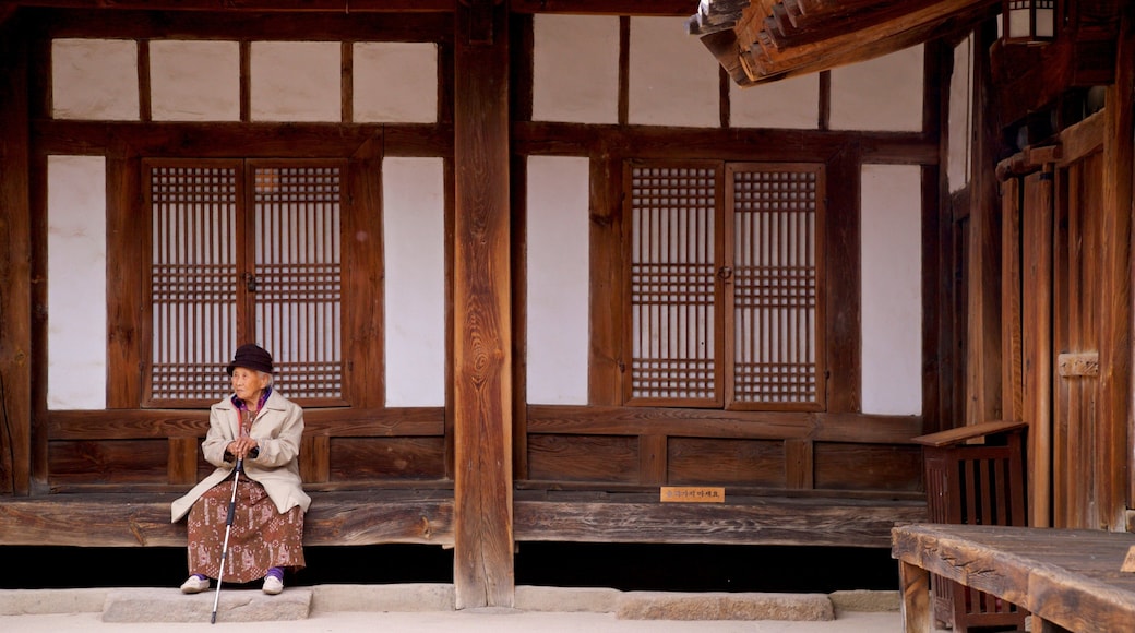 Gyeongju Gyochon Traditional Village showing heritage elements as well as an individual femail