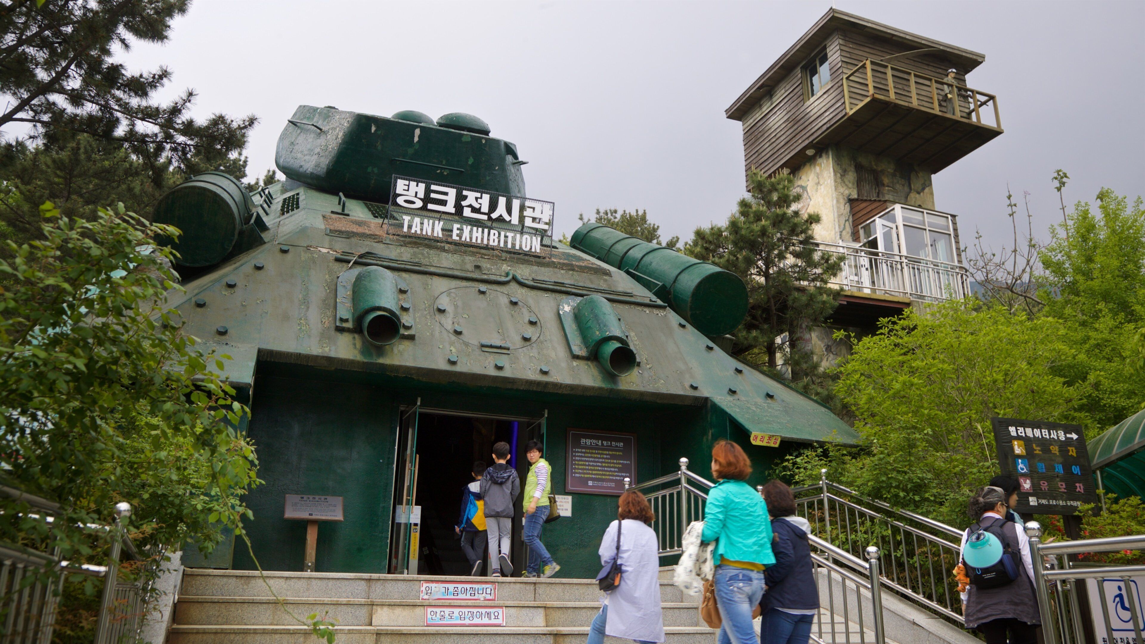 Geoje POW Camp featuring signage and heritage elements as well as a small group of people